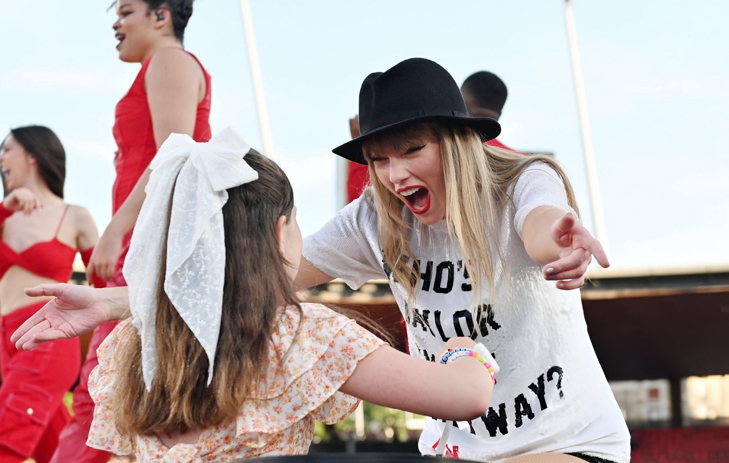 Taylor Swift hugging young Swiftie